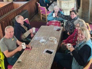 People sitting around a table looking at the camera